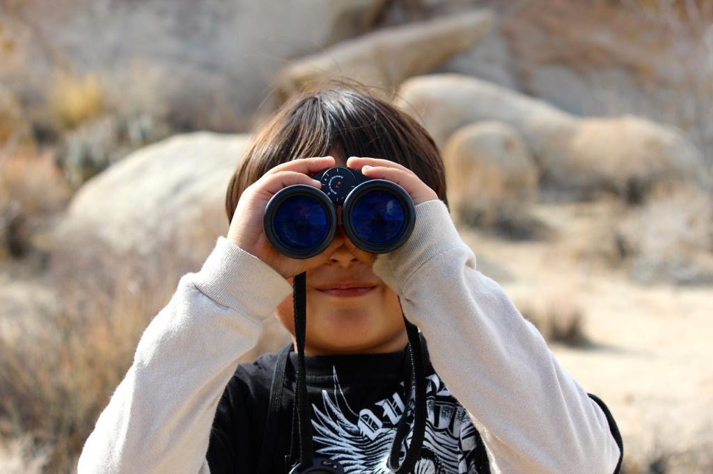 kid wearing binoculars 