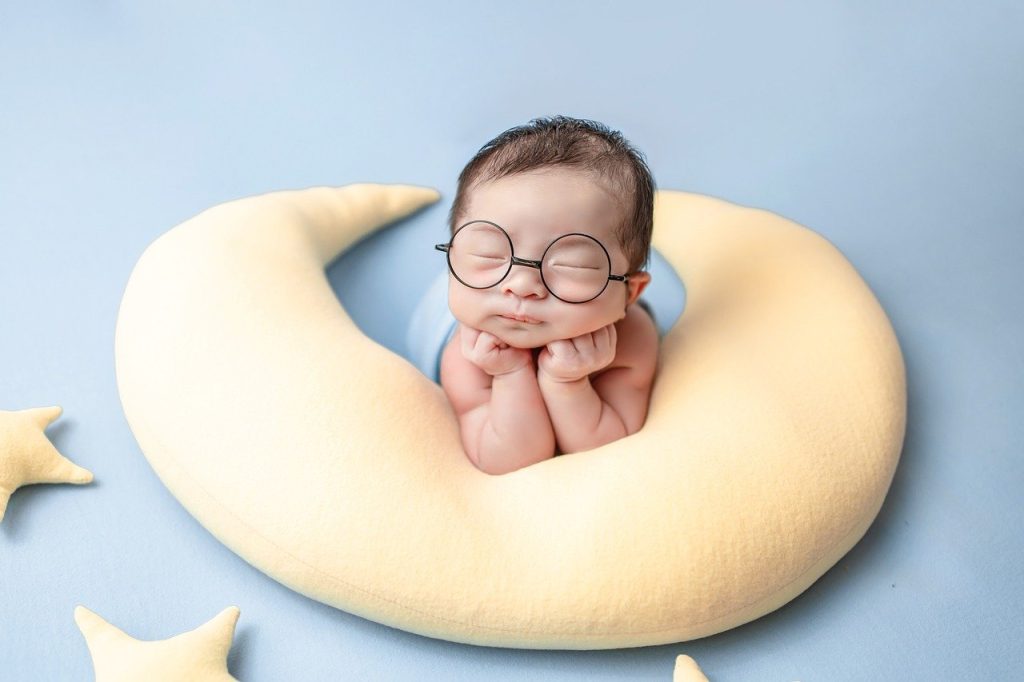 baby with moon pillow